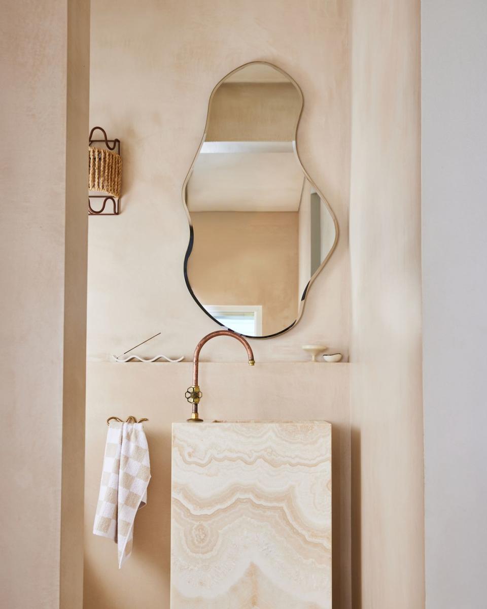 a mirror above a sink in a bathroom