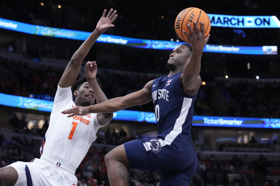 FILE - Penn State's Kanye Clary drives too the basket as Illinois's Sencire Harris defends during the first half of an NCAA college basketball game at the Big Ten men's tournament, Thursday, March 9, 2023, in Chicago. Clary and the Nittany Lions are hoping to build off a promising 2022-23 season in which they reached the NCAA tournament for the first time since 2011. (AP Photo/Charles Rex Arbogast, File)