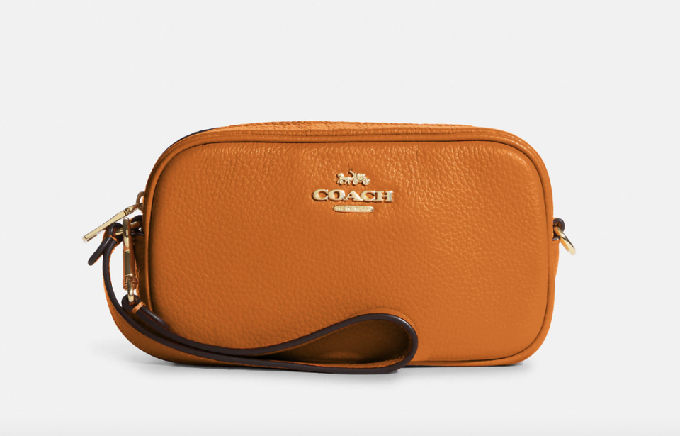 Jamie Wristlet in IM/Light Orange (Photo via Coach Outlet)