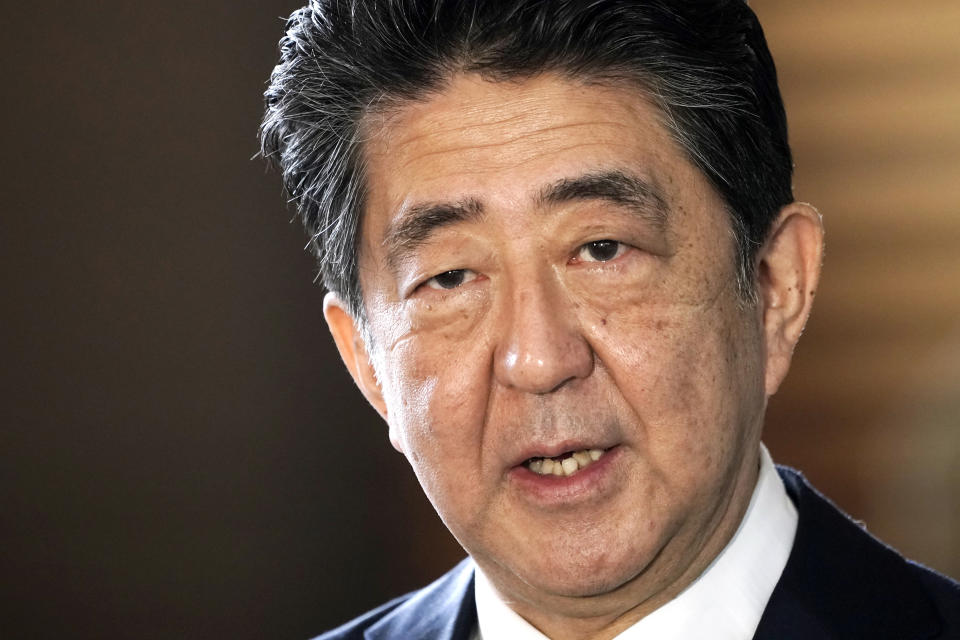 FILE - Japan's outgoing Prime Minister Shinzo Abe speaks to the media as he arrives at the prime minister's office for a cabinet meeting in Tokyo on Sept. 16, 2020. Japanese former Prime Minister Shinzo Abe was assassinated Friday, July 8, 2022, by a gunman who opened fire on him as he delivered a campaign speech on a street in western Japan.(AP Photo/Eugene Hoshiko, File)