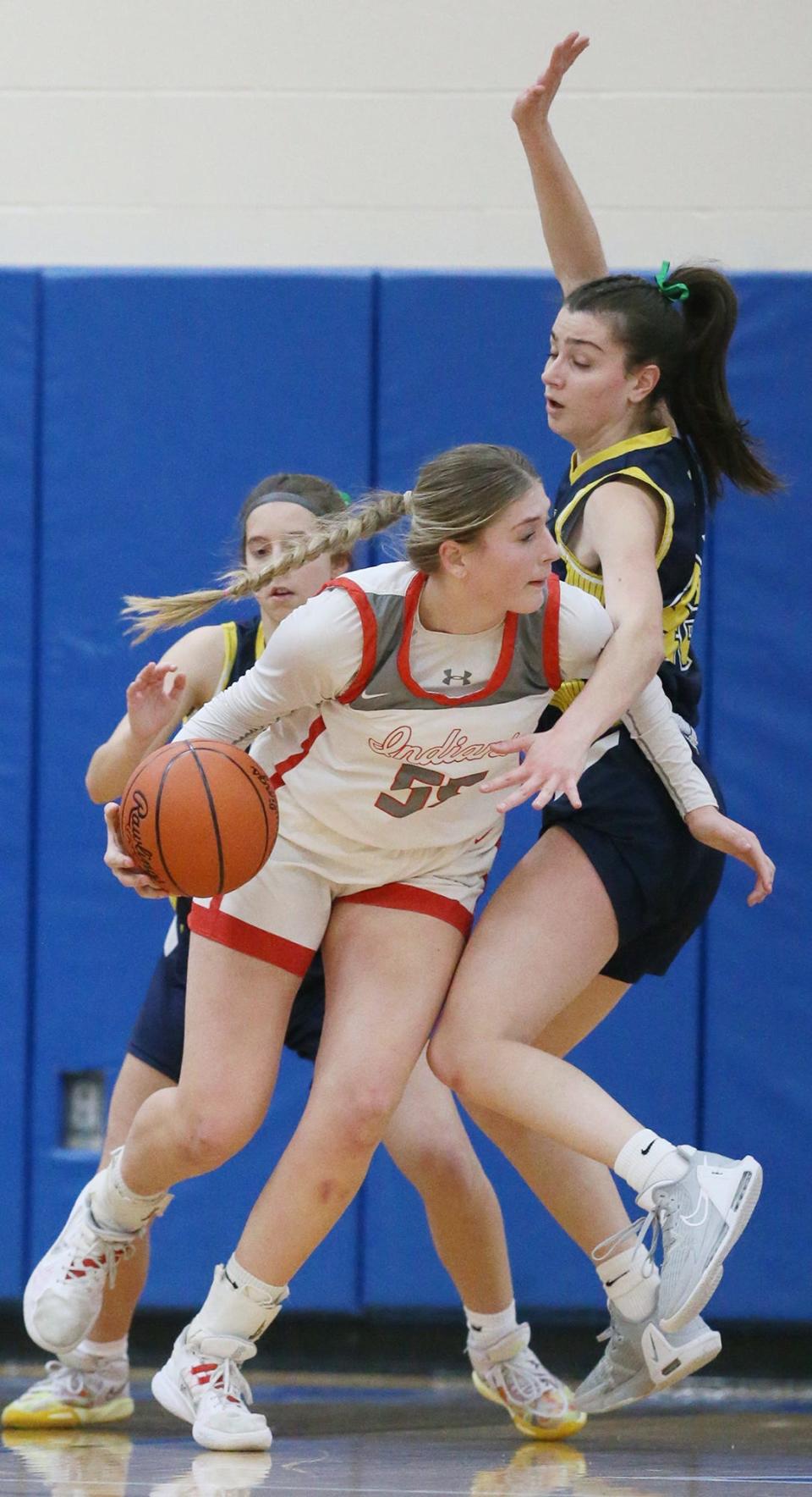 Northwest's Lily Bottomley tries to get away from Tallmadge's Abby Caruso and Isabella Messina during the Div. II girls basketball district semifinals game at Lake High School.