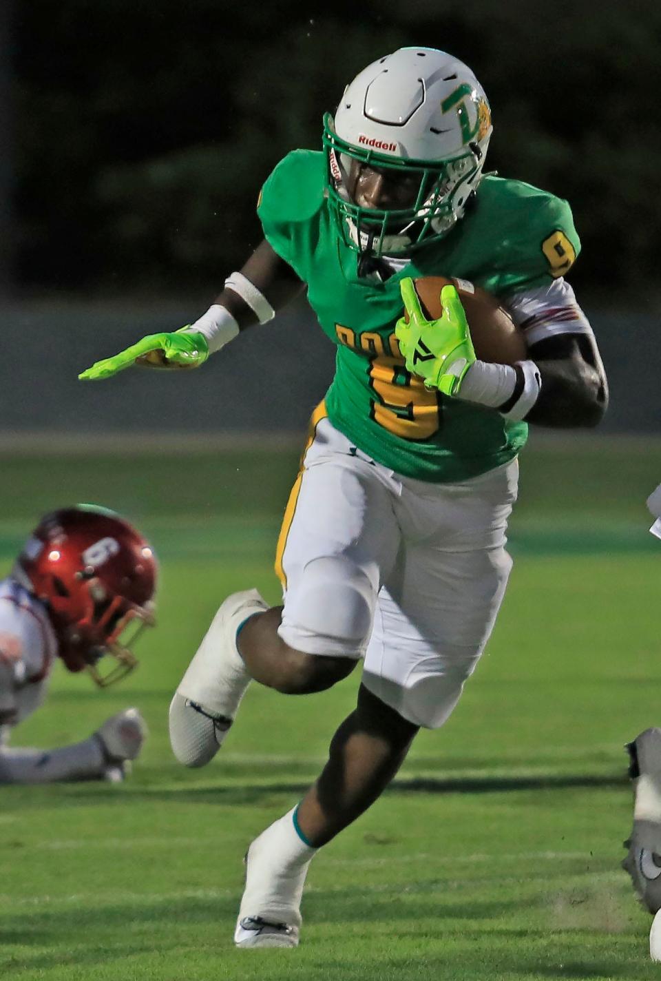Deland (9) Javon Ross runs through the field after catching the ball during Friday nights game.
