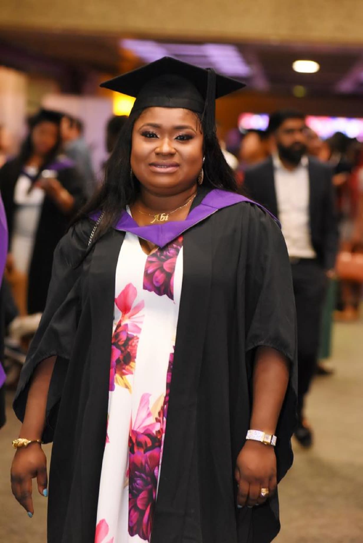 Woman in a graduation cap and gown.