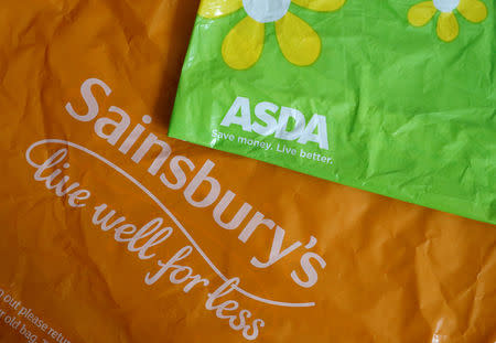 FILE PHOTO: Shopping bags from Asda and Sainsbury's are seen in Manchester, Britain April 30, 2018. REUTERS/Phil Noble/illustration/File Photo