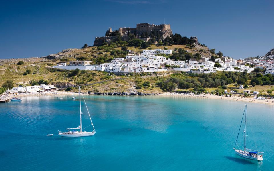 Greek Island of Lindos with beach and Acropolis - Jorg Greuel/Stone RF