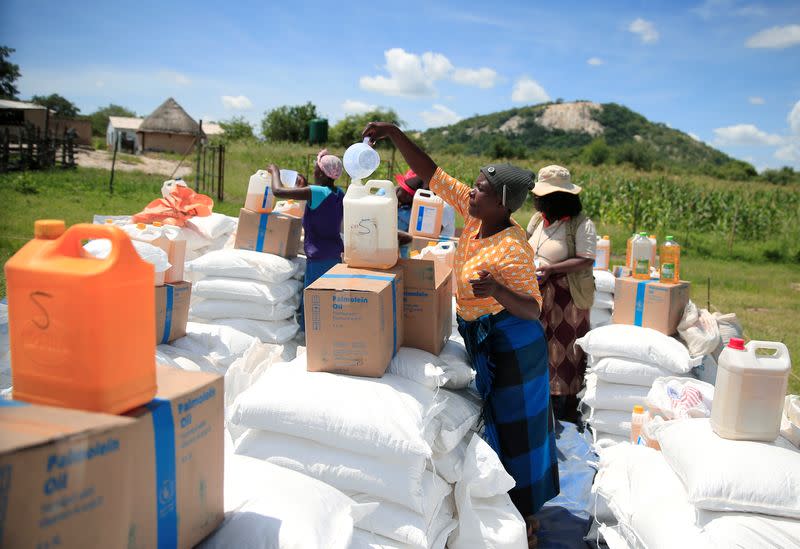 Villagers collect food aid distributed by the World Food Program (WFP) in rural Mudzi district