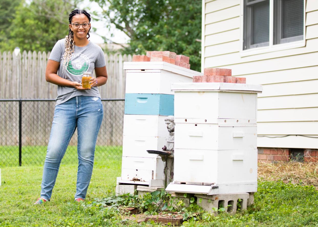 Chillicothe student and 4-H member Haley Laughlin hold up honey created by bees that live in the hive in her backyard in Chillicothe.