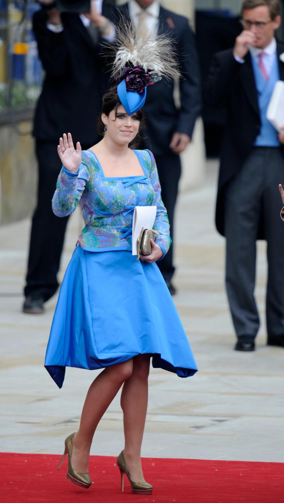 Princess Eugenie waves as she leaves Westminster Abbey in London following the wedding service of Prince William and Kate in 2011 (AFP via Getty Images)