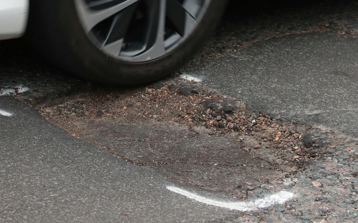 A car hitting a pothole