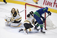 Vancouver Canucks' Loui Eriksson, right, of Sweden, scores a goal as Boston Bruins goalie Tuukka Rask (40), of Finland, watches and Matt Grzelcyk defends during the second period of an NHL hockey game Saturday, Feb. 22, 2020, in Vancouver, British Columbia. (Darryl Dyck/The Canadian Press via AP)