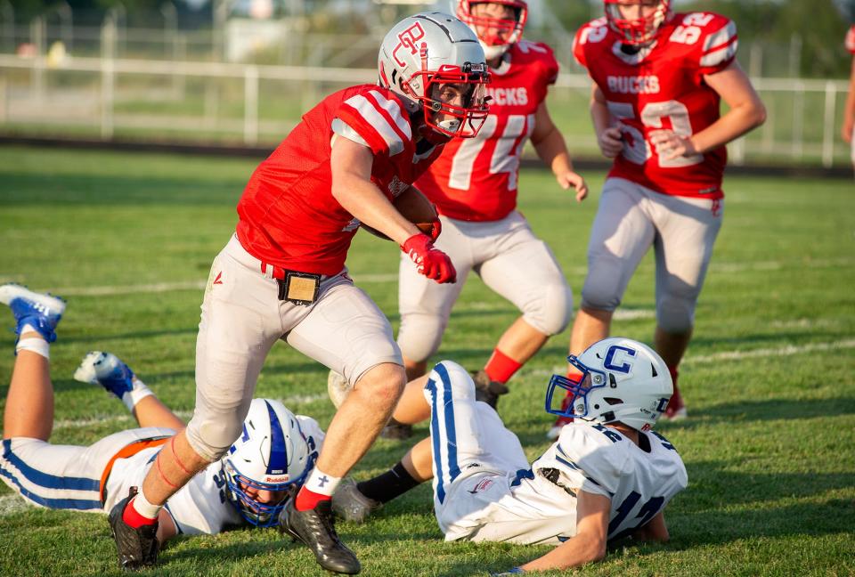 Buckeye Central's Tyler Sanderson slips through the Crestline defense for a big gain.