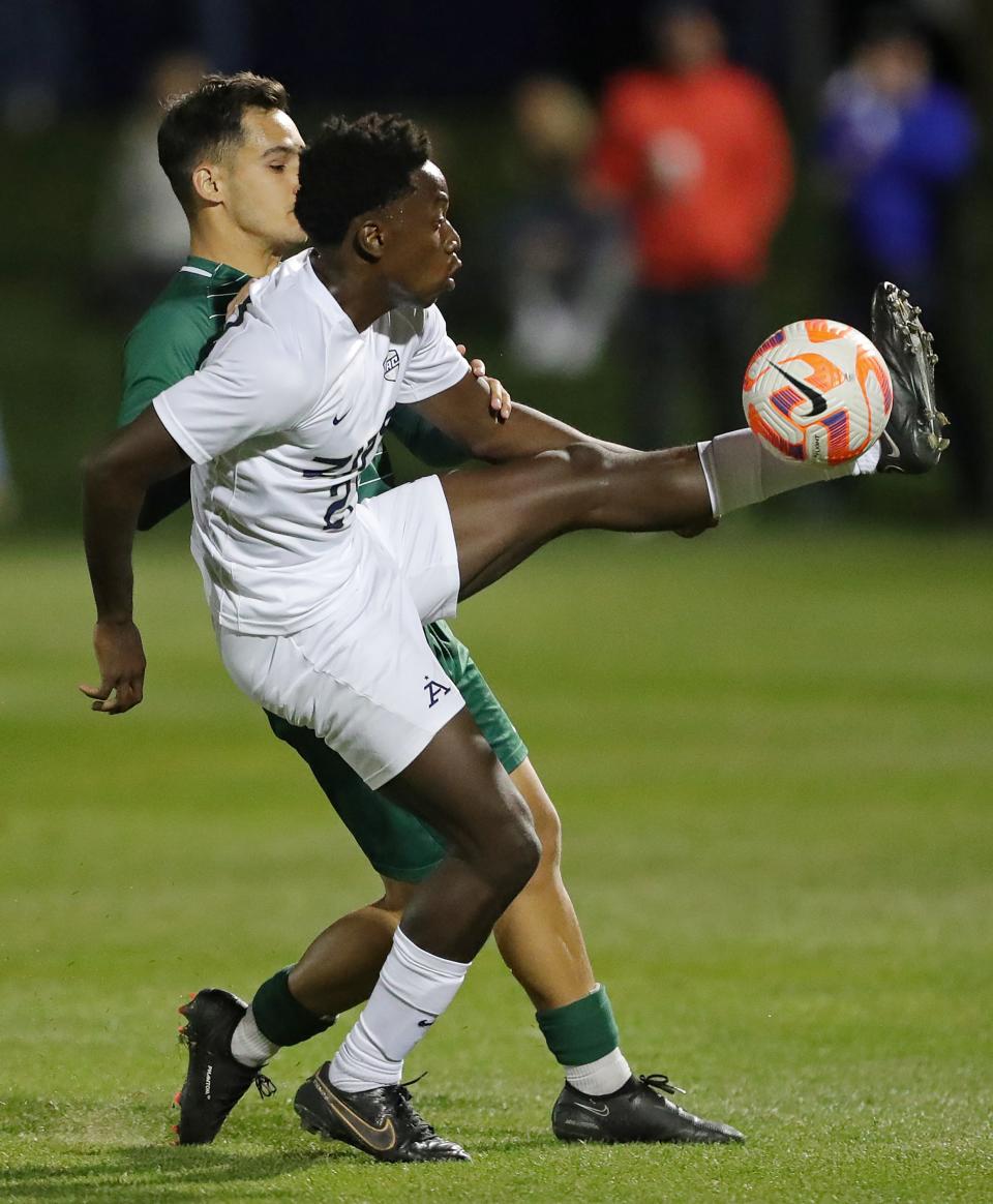 Akron defender Ashton Kamdem keeps the ball in play against Cleveland State midfielder Pablo Kawecki during the first half, Tuesday, Oct. 25, 2022, in Akron.