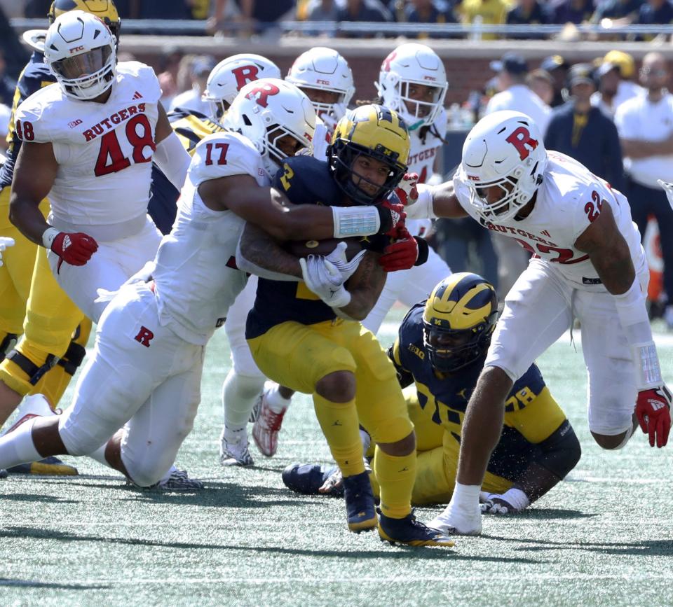 Michigan running back Blake Corum is tackled by Rutgers linebacker Deion Jennings during the second half of Michigan's 31-7 win on Saturday, Sept. 23 2023, in Ann Arbor.