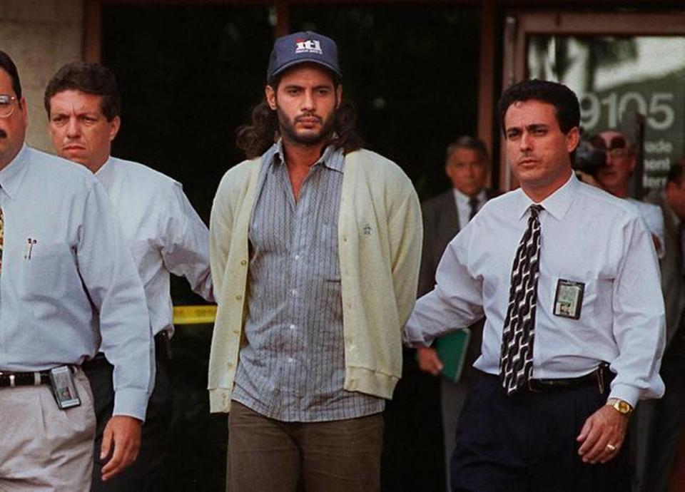 Miami-Dade police detectives escort Juan Carlos Chavez, center, suspect in Jimmy Ryce’s murder, out of police headquarters on Dec. 9, 1995.