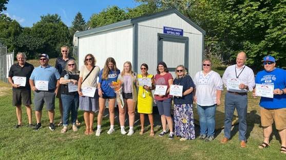 Annabelle Holmes and supporters came out for a ribbon-cutting to mark the installation of a new shed at Hampton Academy for softball equipment.