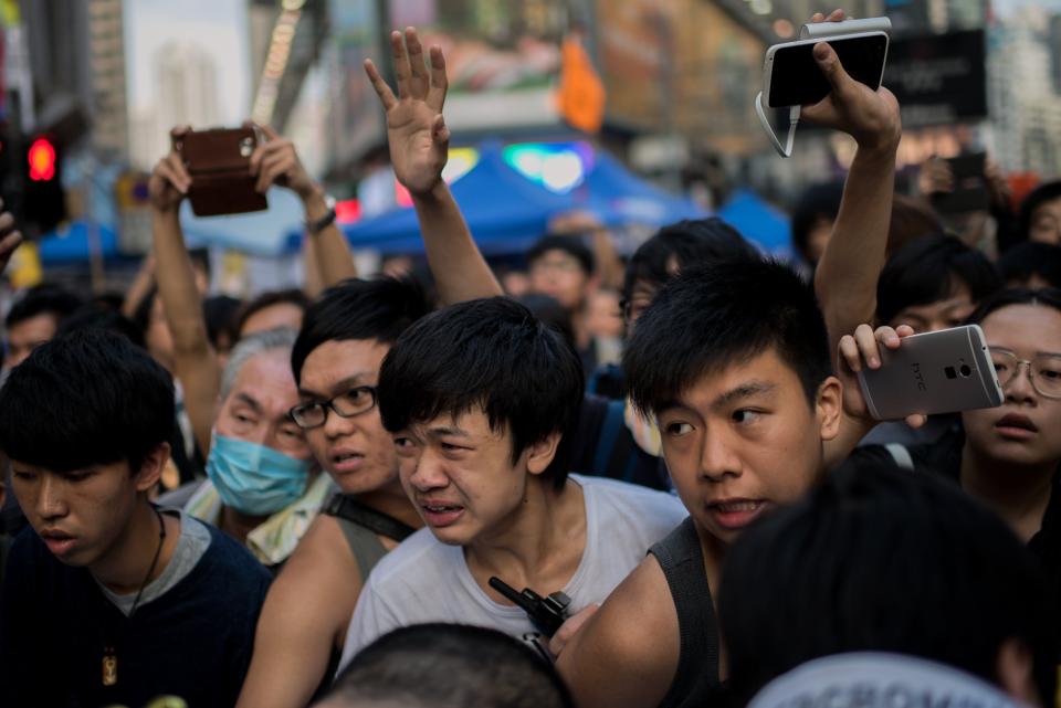 Pro-democracy protesters try to stop a barricade at their demonstration area from being removed in the Causeway Bay district of Hong Kong on October 3, 2014. (Alex Ogle/AFP/Getty Images)