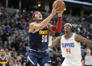 Denver Nuggets forward Aaron Gordon (50) drives to the rim past Los Angeles Clippers guard Terance Mann in the first half of an NBA basketball game Wednesday, Jan. 19, 2022, in Denver. (AP Photo/David Zalubowski)