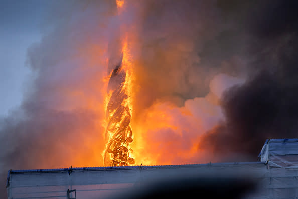 The tower of the historic Boersen stock exchange stands in flames as the building is on fire in central Copenhagen, Denmark on April 16, 2024. The building, one of the oldest in the Danish capital, was undergoing renovation work when in the morning it caught fire, whose cause was yet unknown. The building was erected in the 1620s as a commercial building by King Christian IV and is located next to the Danish parliament. (Photo by Ida Marie Odgaard / Ritzau Scanpix / AFP) / Denmark OUT (Photo by IDA MARIE ODGAARD/Ritzau Scanpix/AFP via Getty Images)