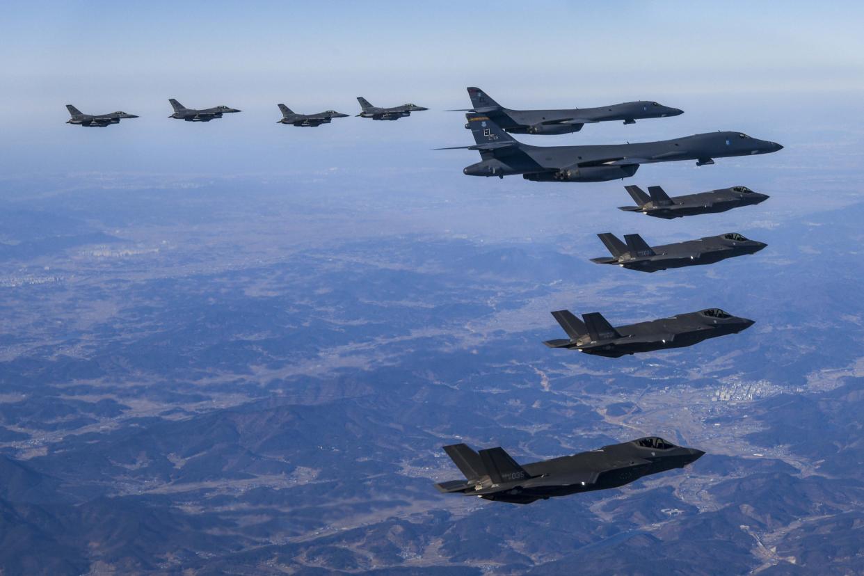 In this photo provided by South Korea Defense Ministry, U.S. Air Force B-1B bombers, center, fly in formation with South Korea's Air Force F-35A fighter jets, bottom, and U.S. Air Force F-16 fighter jets, top, over the South Korea Peninsula during a joint air drill in South Korea, Sunday, Feb. 19, 2023. (South Korea Defense Ministry via AP)