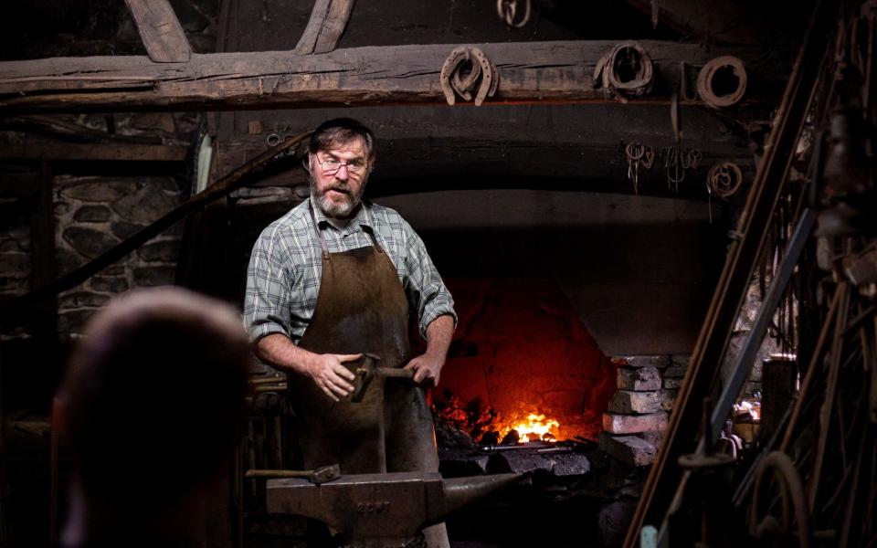 A blacksmith speaks about his trade at St Fagans National Museum of History in Cardiff