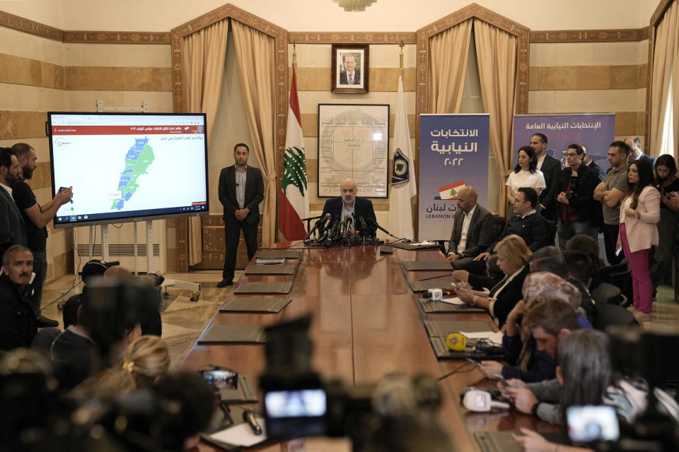 Lebanese Interior Minister Bassam Mawlawi, center, speaks during a press conference about Sunday's parliamentary elections, at the interior ministry in Beirut, Lebanon, Monday, May 16, 2022. Lebanon's militant Hezbollah group and its allies suffered losses in this weekend's parliamentary elections, with preliminary results Monday showing some of their most vocal opponents picking up more seats and several of their traditional partners routed out of the legislature. (AP Photo/Hassan Ammar)