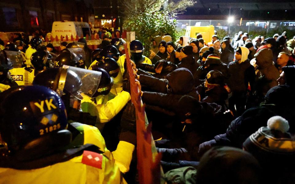 Police try and hold back the travelling fans