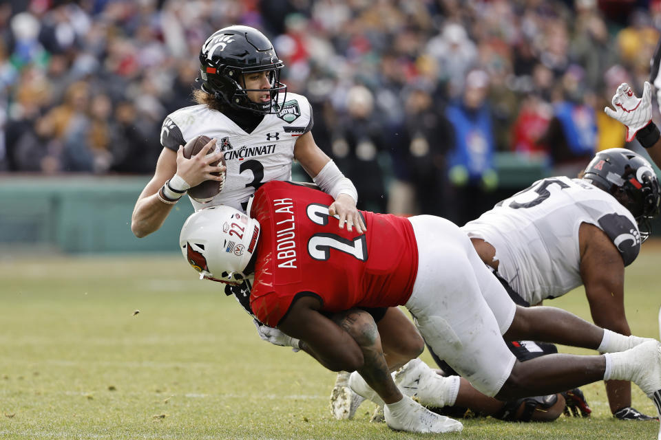 Cincinnati quarterback Evan Prater is sacked by Louisville's Yasir Abdullah during the second quarter of the Fenway Bowl NCAA college football game at Fenway Park Saturday, Dec. 17, 2022, in Boston. (AP Photo/Winslow Townson)