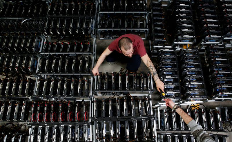 FILE PHOTO: Employees work on bitcoin mining computers at Bitminer Factory in Florence