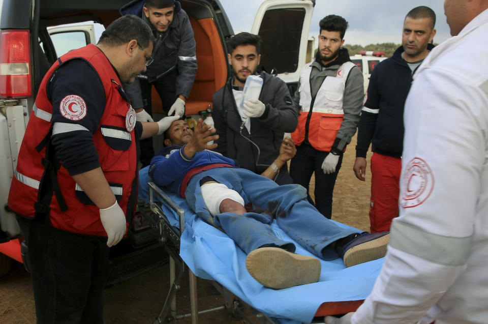 Medics move a wounded protestor to the field clinic tent after he was shot during a protest near the fence of the Gaza Strip border with Israel, near Beit Lahiya, northern Gaza Strip, Tuesday, Feb. 19, 2019. (AP Photo/Adel Hana)