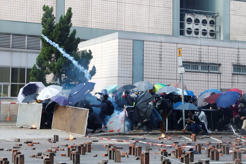 Protesters are detained by riot police while attempting to leave the campus of Hong Kong Polytechnic University (PolyU) during clashes with police in Hong Kong