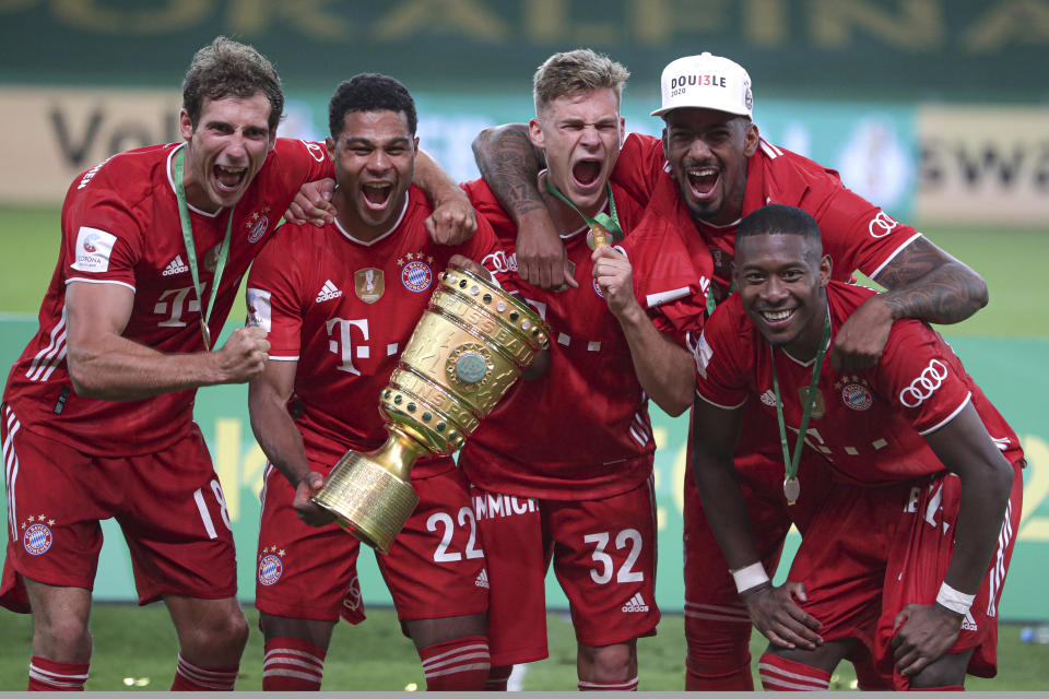 Bayern Munich players celebrate with the trophy after winning the German soccer cup (DFB Pokal) final match between Bayer 04 Leverkusen and FC Bayern Munich in Berlin, Germany, Saturday, July 4, 2020. (AP Photo/Michael Sohn)