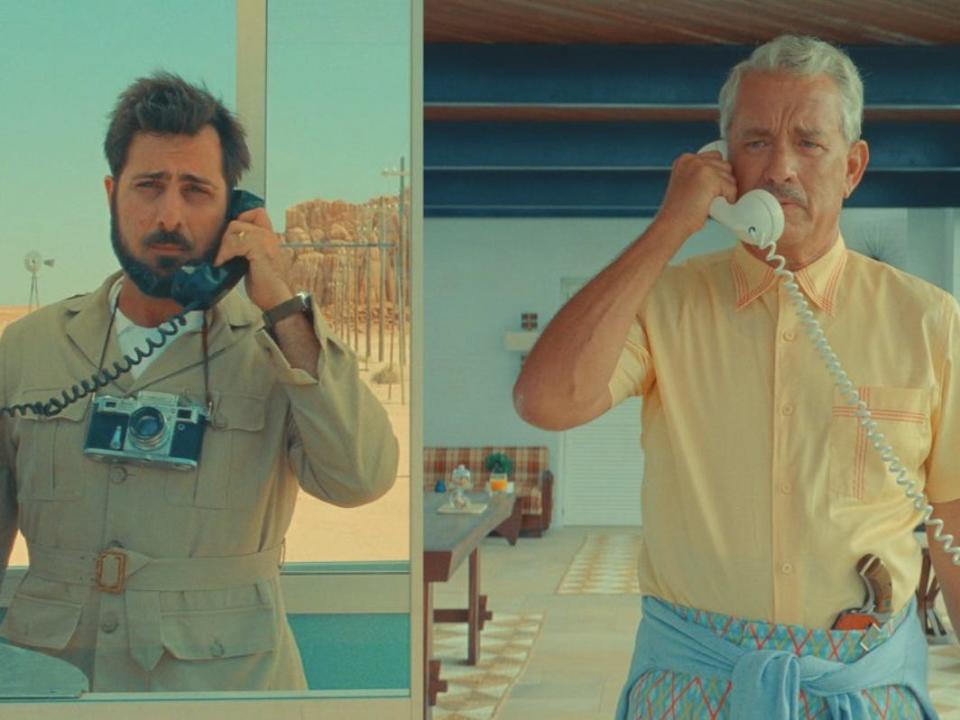 A still from Asteroid City of two men on the phone in different locations