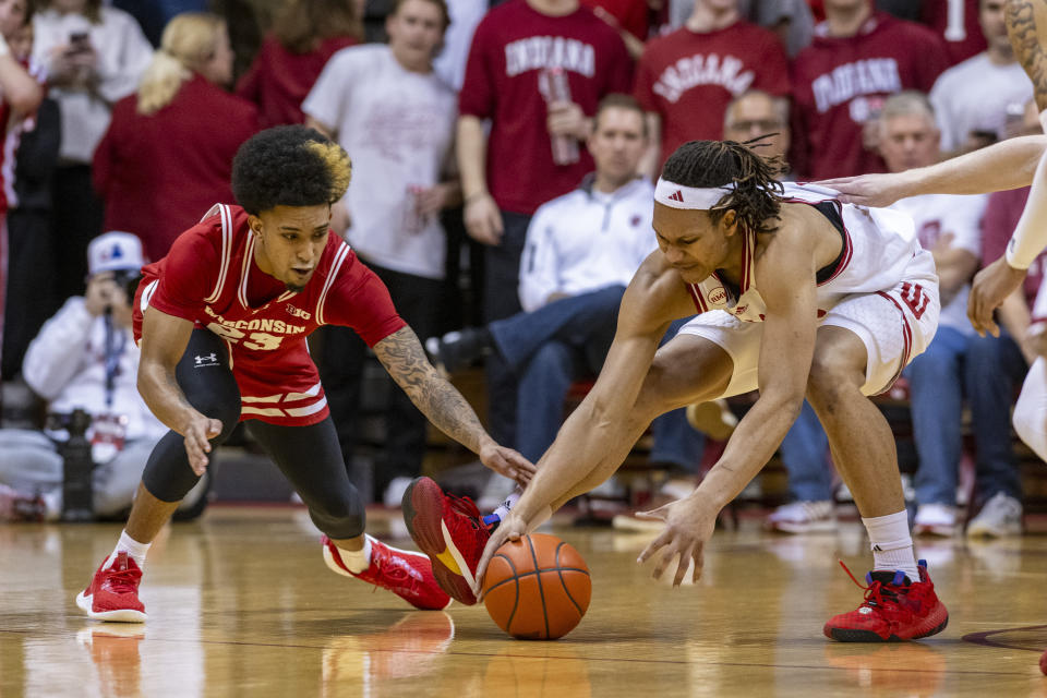 Wisconsin guard Chucky Hepburn, left, and Indiana forward Malik Reneau reach for the ball during the first half of an NCAA college basketball game, Tuesday, Feb. 27, 2024, in Bloomington, Ind. (AP Photo/Doug McSchooler)