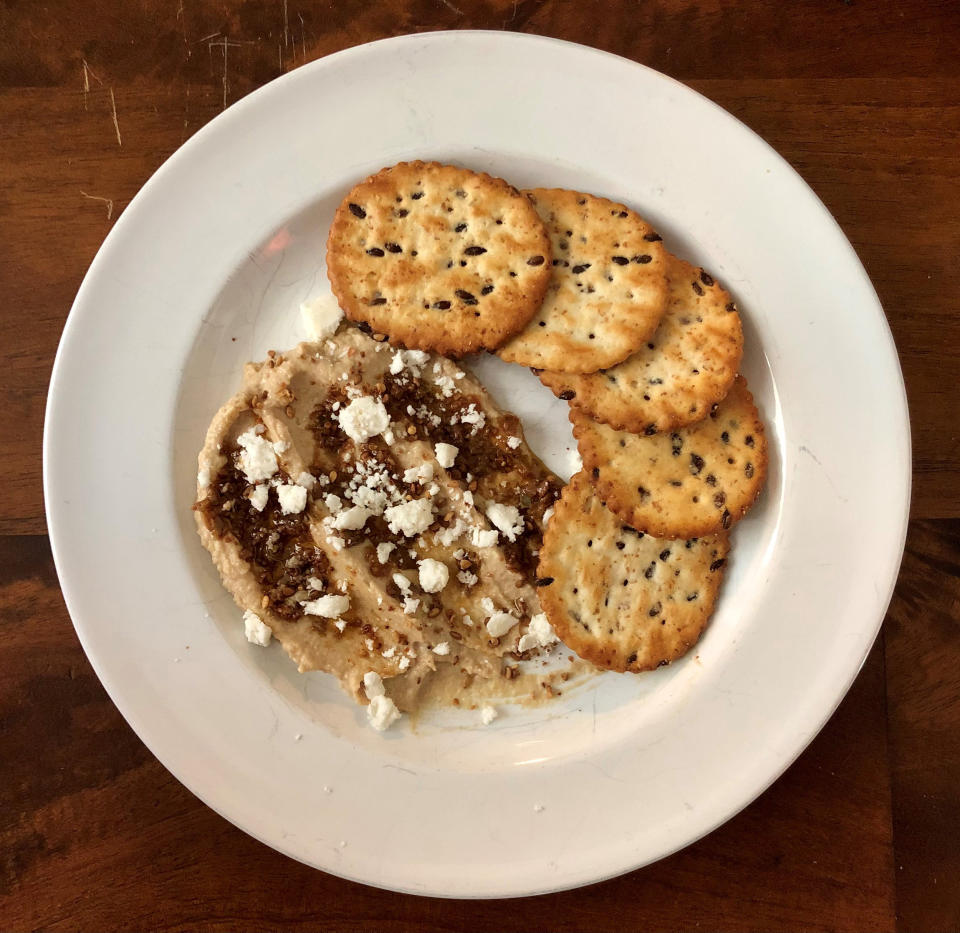 Sprinkles always make it better. Back to Nature crackers with hummus, tapenade and a feta garnish. (Heather Martin)
