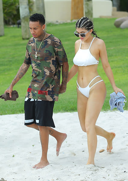 So can we finally assume Kylie Jenner and Tyga are now officially a couple? The controversial pair was spotted holding hands on Thursday during their Mexico vacay with Kylie's close gal pals, which is pretty tame, except that the two have been very, very careful to keep their PDA out of the public eye. Given that Kylie's legal now -- she celebrated her 18th birthday on Monday -- we can only assume this is the start. Clad in a white two-piece bikini and rocking cornrows, Kylie clasped hands with the 25-year-old "Rack City" rapper on the beach. <strong>WATCH: EXCLUSIVE -- Kylie Jenner & Tyga Stay at 'Girls Gone Wild' House During Mexico Vacation</strong> Splash News And that's not the only PDA the two were showing. Check out Kylie lying between Tyga's legs on a yacht. FameFlynet Kylie, Tyga, and the reality star's friends Stassi, Jordyn, Justine Skye, and Pia Mia, have been staying at <em>Girls Gone Wild </em>founder Joe Francis' house in Casa Aramara -- a private, seaside estate -- since Tuesday. On Thursday, Kendall Jenner and her bestie Hailey Baldwin flew in to join the festivities, as well as 42-year-old Francis himself. The group all hung out on the beach, riding on jet skis and showing off their bikini bodies. <strong>NEWS: Meet Kylie Jenner's Squad -- Singers, Social Media Stars, and Will Smith's Goddaughter!</strong> Although Kylie and Tyga have never outright confirmed their dating status, they also haven't been discreet about their affection for one another either. On Sunday, Tyga gifted Kylie with a white Ferrari 482 Italia -- reportedly worth $320,000 -- for her birthday, when she celebrated at Bootsy Bellows nightclub in Hollywood with friends and family. In February, he gushed over a then-underage Kylie during an interview with radio station Hot 97. "I love her and I love her as a person," he said. Late last month, Kylie's big sis, Khloe Kardashian, all but confirmed their reported relationship, when she defended the two to <em>Complex </em>magazine. "I think at 16 I was probably f**king someone that was in their 20s, for sure," she admitted. "I wouldn't say I was even dating, probably just sleeping with them. But again Kylie is not a normal 17-year-old." "Kylie is taking business meetings and bought her first house, or she's going on a private plane with Karl Lagerfeld to take a meeting," she added. "That's not even what people do in their 30s. It's a rare circumstance, so let's treat this as a special case." <strong>WATCH: Kanye West on Kylie & Tyga's Relationship -- 'I Think He Got In Early, I Think He Was Smart'</strong> Watch below: