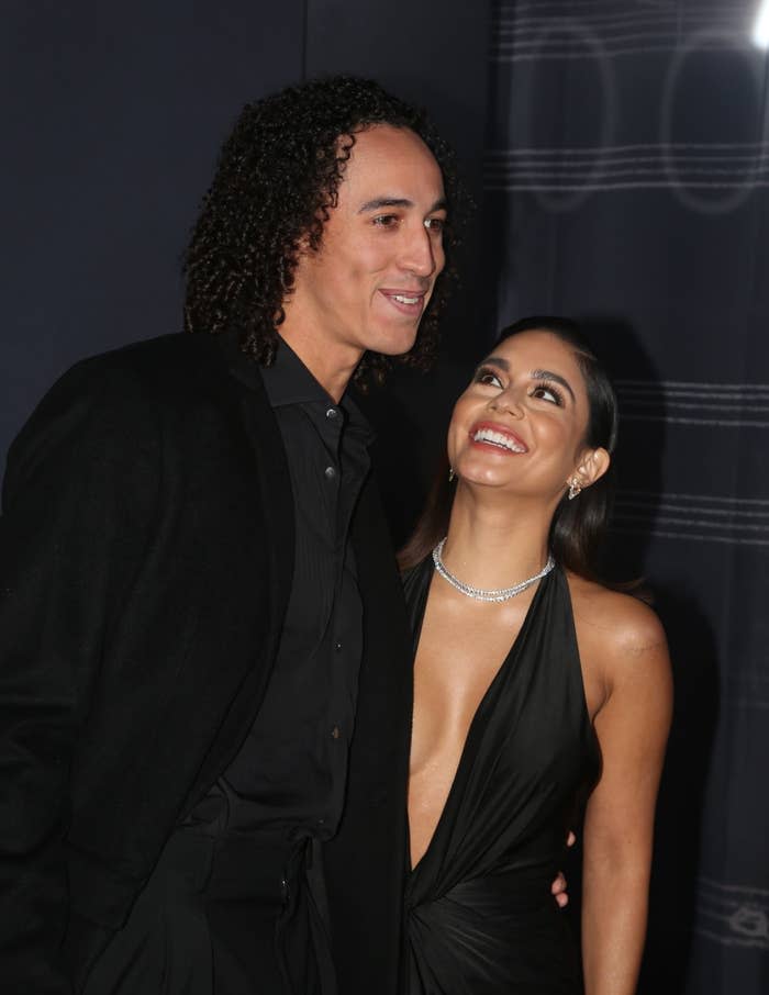 Close-up of Cole and Vanessa smiling and hugging at a media event