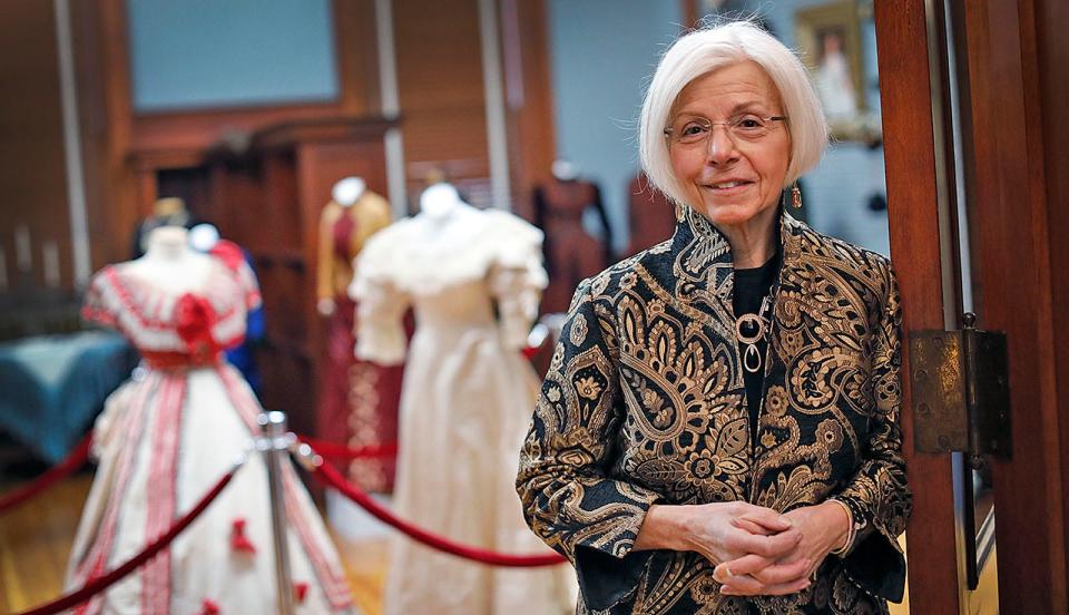 Costume and textile manager Marie Schlag wears a gold and black brocade jacket from the exhibit "Flounces, Furbelows and Fripperies: The Gilded Age in Cohasset," which will open Jan. 14 at the Cohasset Historical Society at 104 S. Main St.