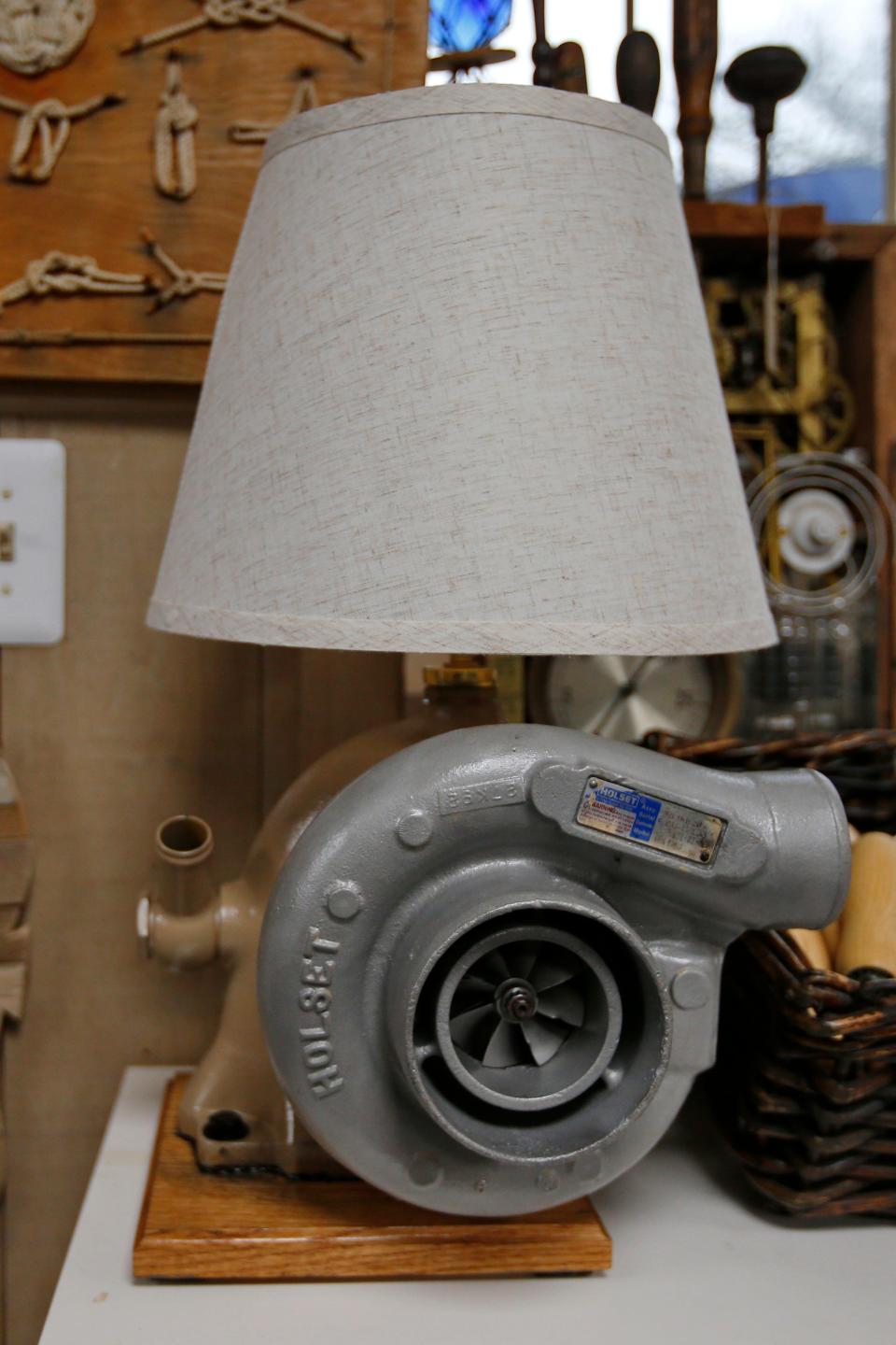 A lamp made using a used fishing boat engine turbo is one of the many interesting items for sale at the recently opened Ocean Drive Screenprinting on MacArthur Drive in New Bedford.