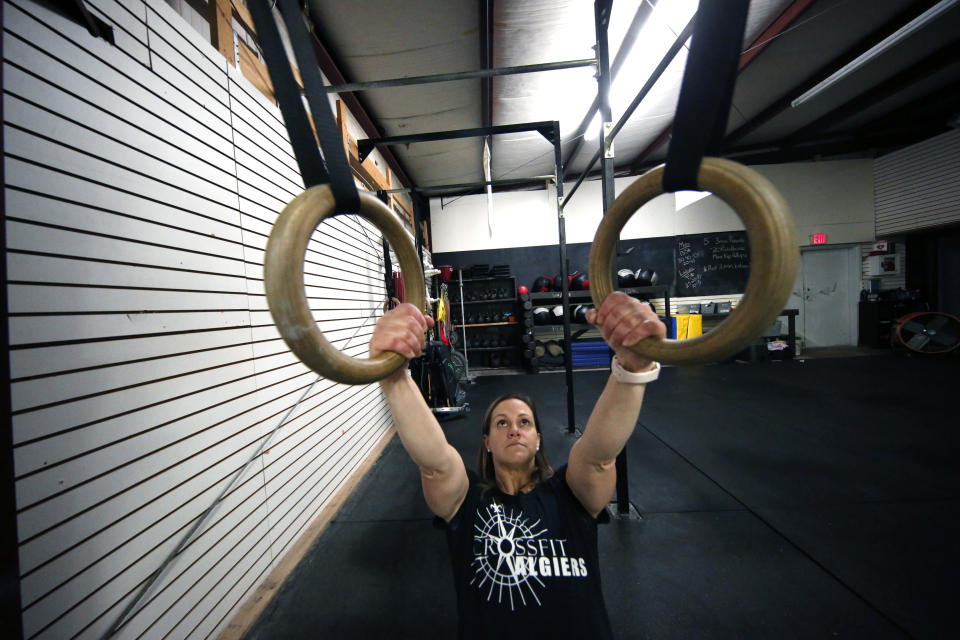 Melissa Breaux Bankston, a CrossFit athletic trainer at CrossFit Algiers in New Orleans, works out at the gym Monday, Dec. 23, 2019. She participates in an intermittent fasting diet. (AP Photo/Gerald Herbert)