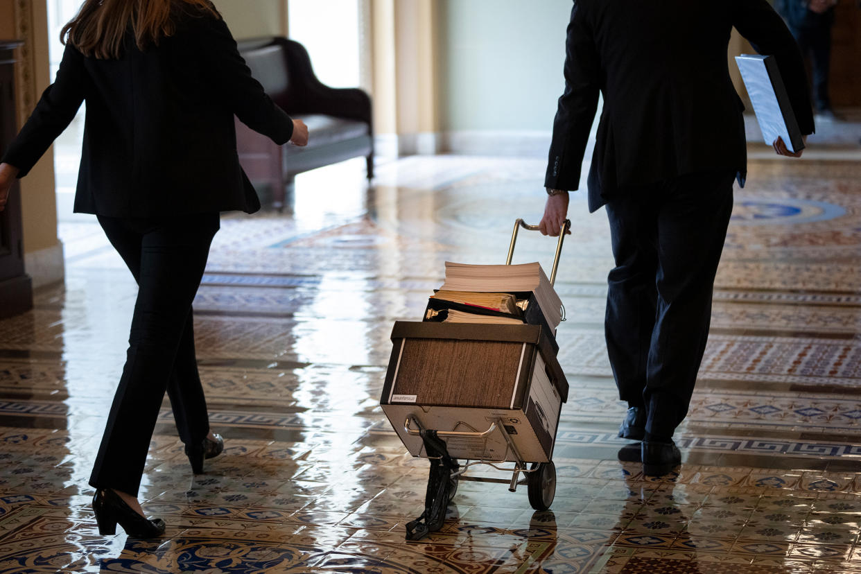 Documents, including text of the bipartisan infrastructure legislation, is wheeled toward the office of Senate Majority Leader Chuck Schumer at the Capitol in Washington, D.C, on Aug. 2, 2021.