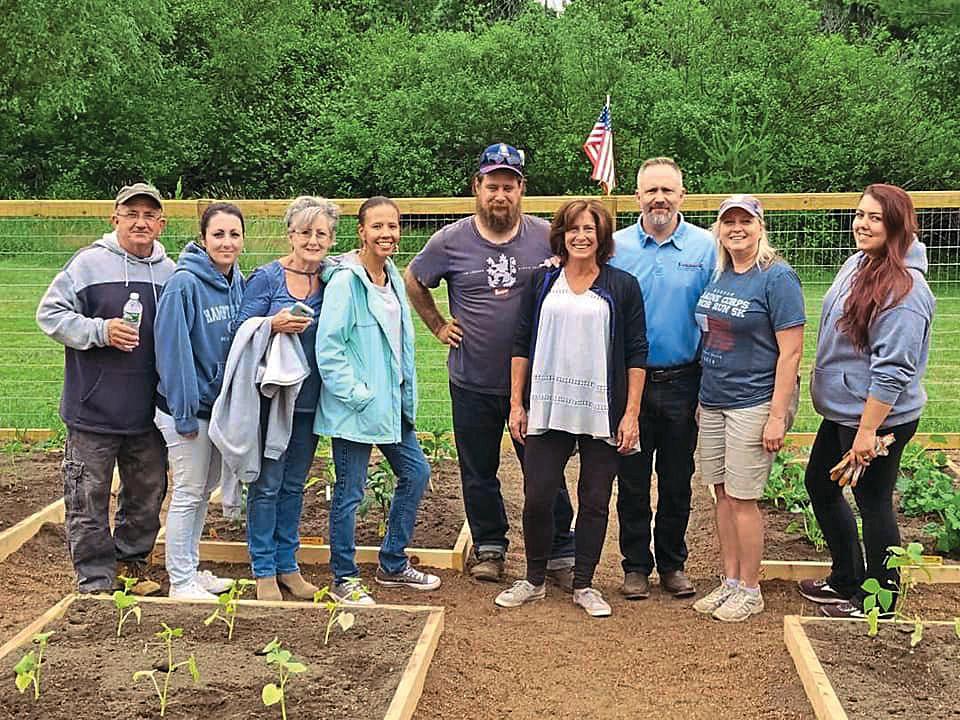 <span><span>Anne Marie and Jason (center) with volunteers</span><span>Veterans Garden</span></span>