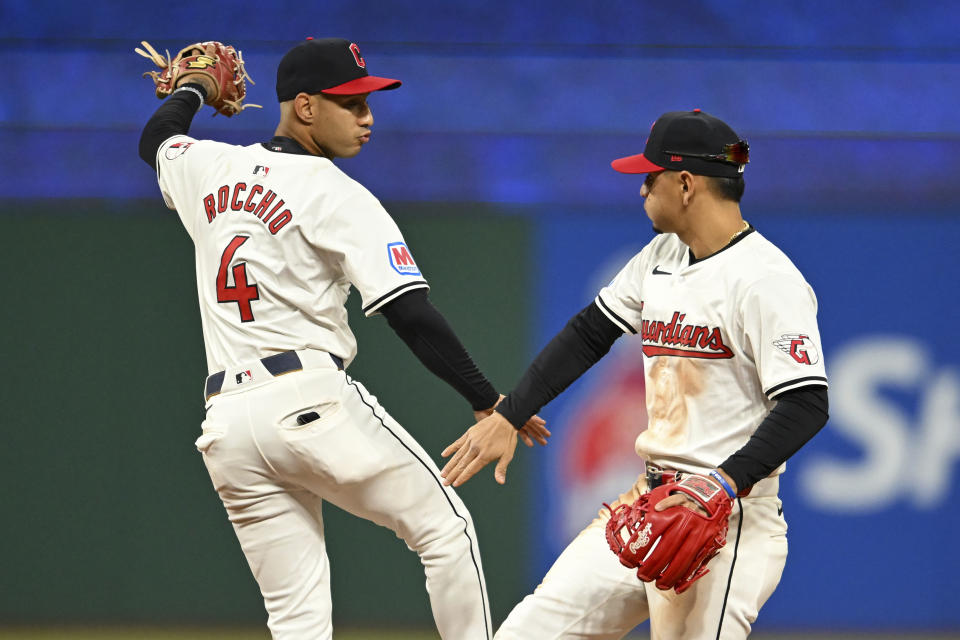 Cleveland Guardians' Brayan Rocchio (4) and Andrés Giménez, right, celebrate their win over the Oakland Athletics in a baseball game, Friday, April 19, 2024, in Cleveland. (AP Photo/Nick Cammett)