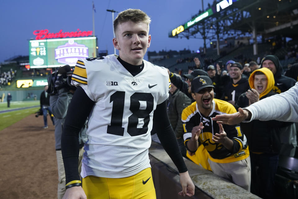 Iowa place-kicker Drew Stevens (18) greets fans after his team's win over Northwestern in an NCAA college football game Saturday, Nov. 4, 2023, at Wrigley Field in Chicago. (AP Photo/Erin Hooley)