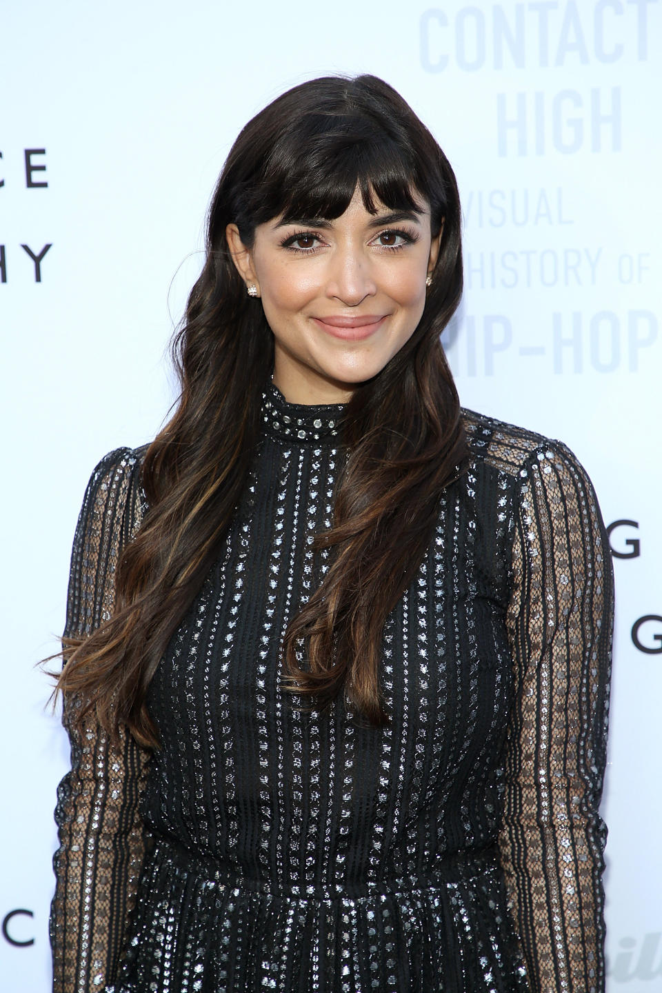 Hannah Simone smiles at an event