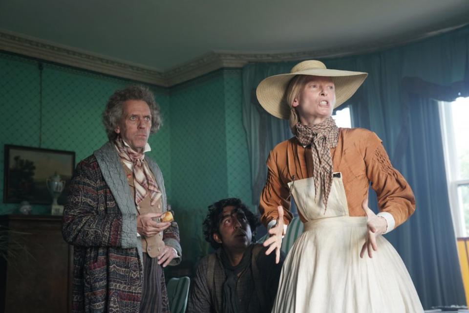 (From L-R): Hugh Laurie, Dev Patel and Tilda Swinton in the film THE PERSONAL HISTORY OF DAVID COPPERFIELD. Photo by Dean Rogers. © 2020 20th Century Studios All Rights Reserved