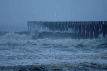 Waves crash along a pier as Hurricane Michael approaches Panama City Beach, Florida, U.S. October 10, 2018. REUTERS/Jonathan Bachman