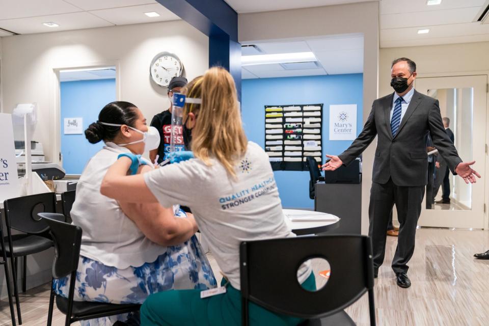 Second Gentleman Douglas Emhoff looks on as Jessica Palacios receives a COVID-19 vaccine from nurse Eva Sweeny Tuesday, March 30, 2021, at Mary’s Center in Silver Spring, Maryland.