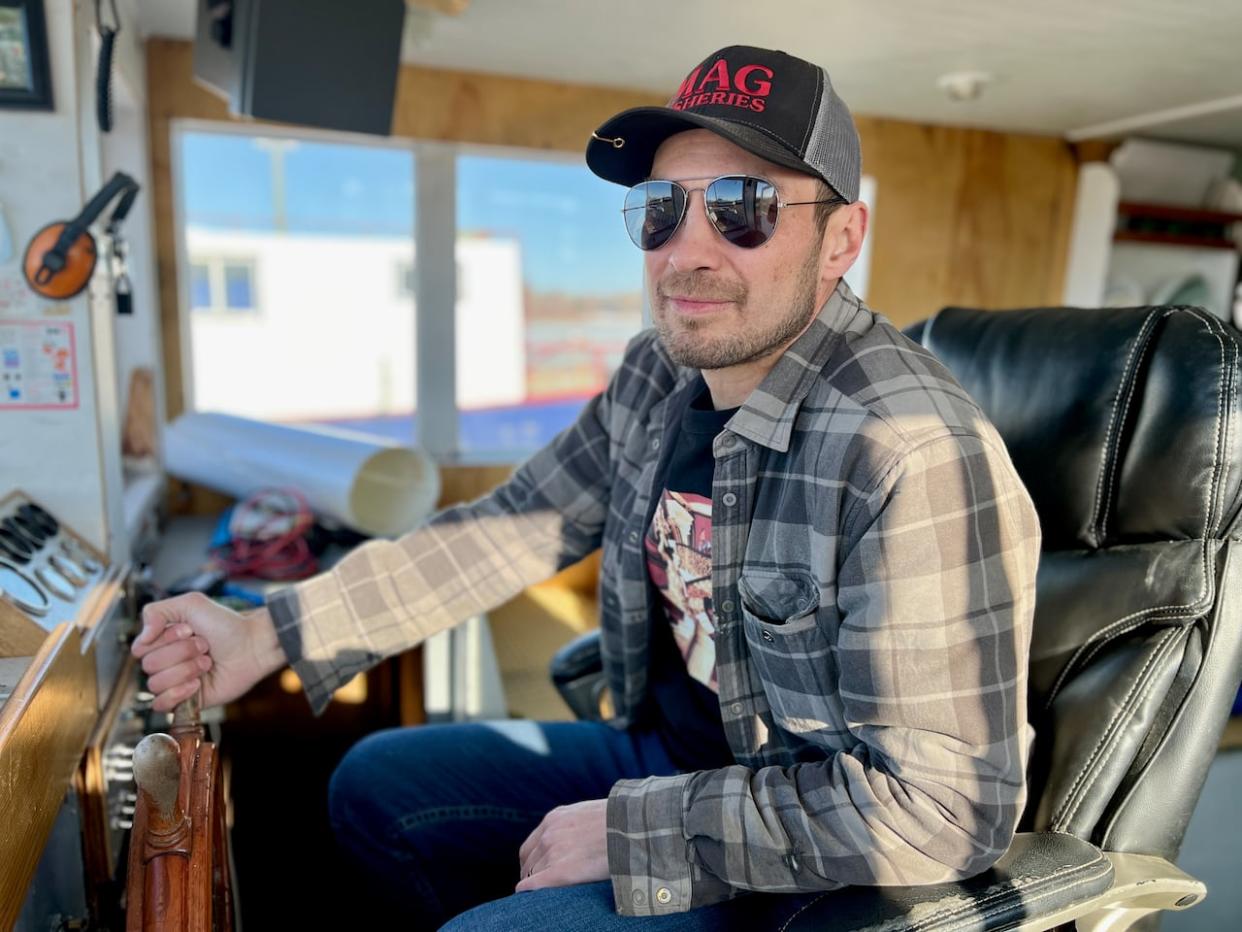 Aaron Campbell of Hay River, N.W.T., on his primary boat which he uses to supply fish to his cannery and fish-smoking business. Campbell is frustrated by what he feels is unreasonable scrutiny by fisheries officers. (Carla Ulrich/CBC - image credit)