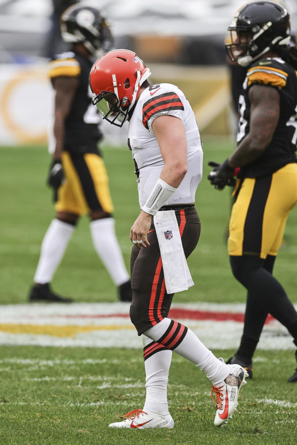 Cleveland Browns quarterback Baker Mayfield (6) tries to recover from a sack as he walks off the field during an NFL game against the Pittsburgh Steelers, Sunday, Oct. 18, 2020, in Pittsburgh. The Steelers defeated the Browns 38-7. (Margaret Bowles via AP)