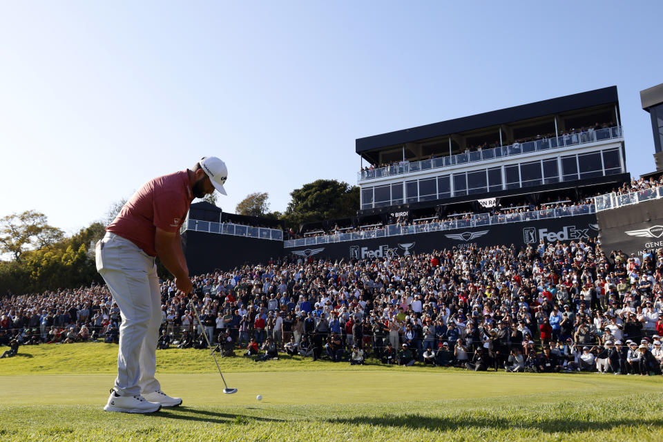 Jon Rahm putts on the 18th green during the final round of the Genesis Invitational golf tournament at Riviera Country Club, Sunday, Feb. 19, 2023, in the Pacific Palisades area of Los Angeles. (AP Photo/Ryan Kang)